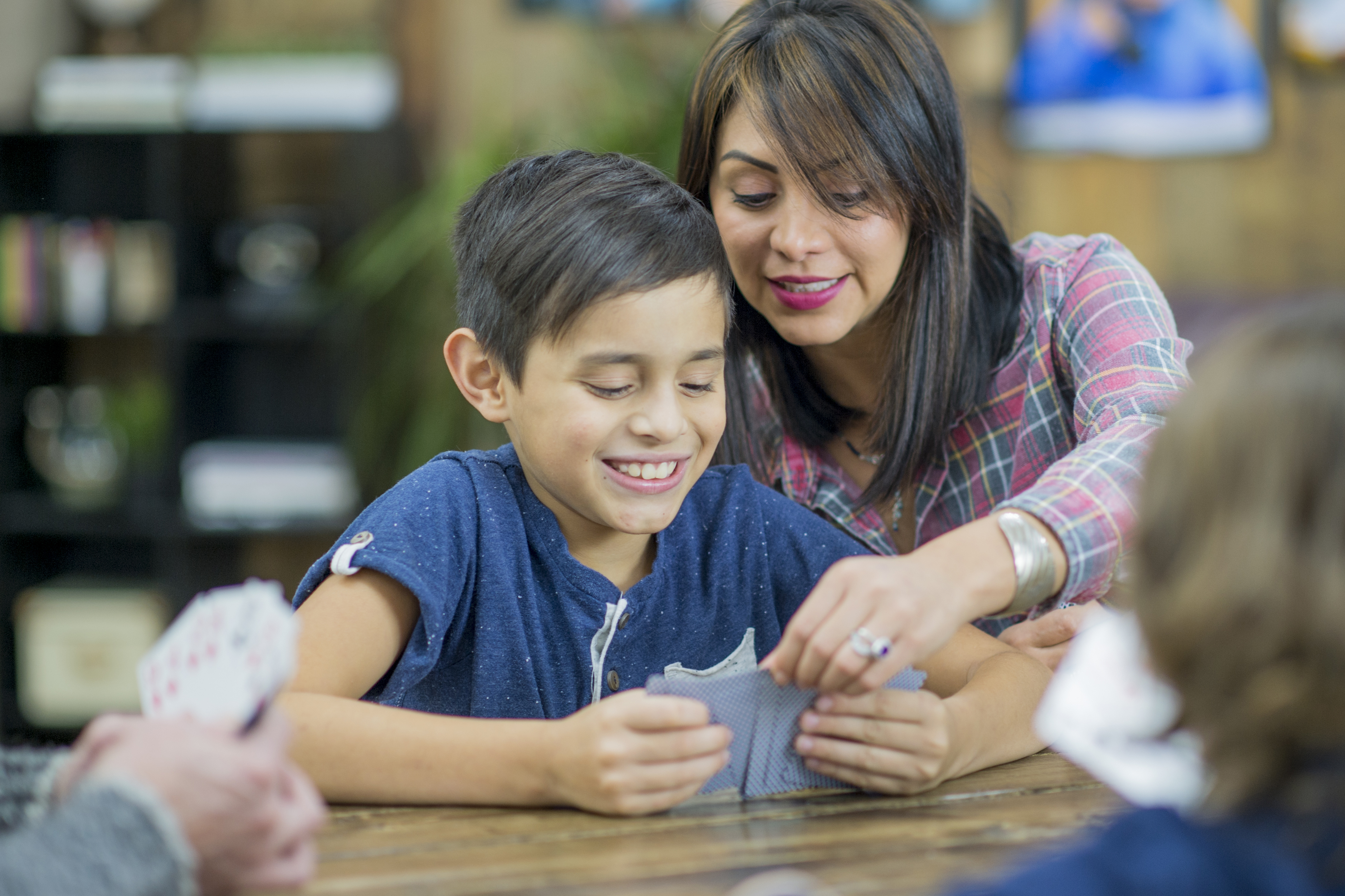 Mother helping son with hands-on math activity at home
