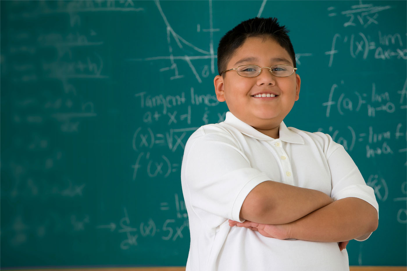 Student solving math problem at chalkboard using visual models
